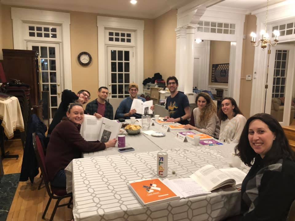 Drexel students learning and discussing Torah around the table